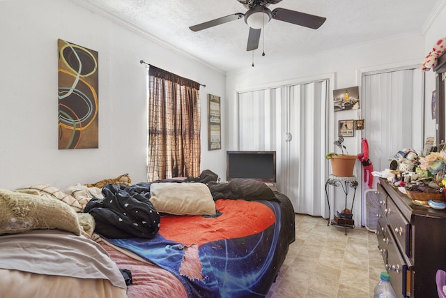 bedroom featuring ceiling fan, a textured ceiling, and ornamental molding