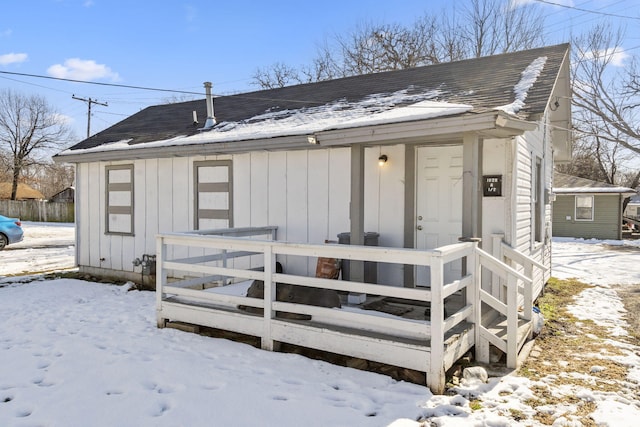 snow covered house featuring central air condition unit