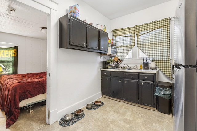 kitchen featuring sink and stainless steel fridge