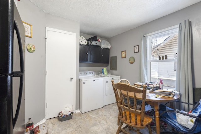 interior space featuring cabinets, a textured ceiling, electric panel, and washing machine and dryer