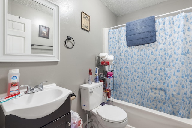 full bathroom featuring toilet, vanity, a textured ceiling, and shower / bathtub combination with curtain