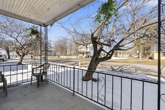 view of snow covered back of property