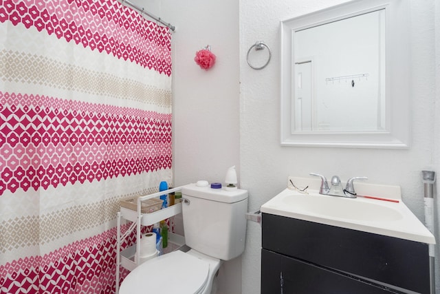 bathroom with toilet and vanity