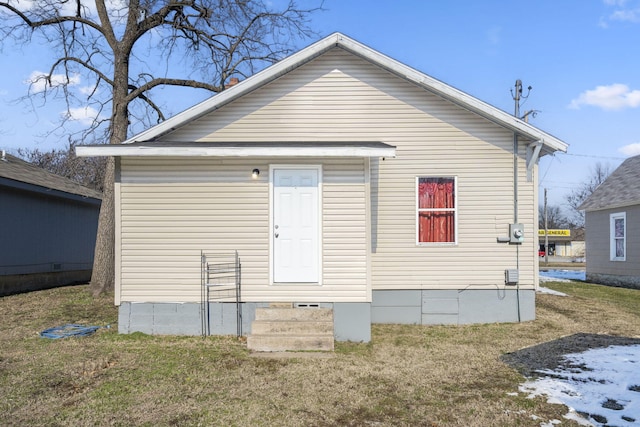 rear view of house with a lawn