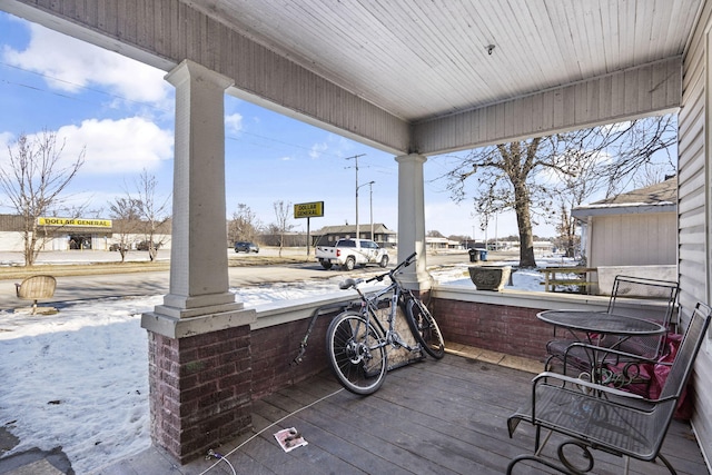 snow covered deck with covered porch