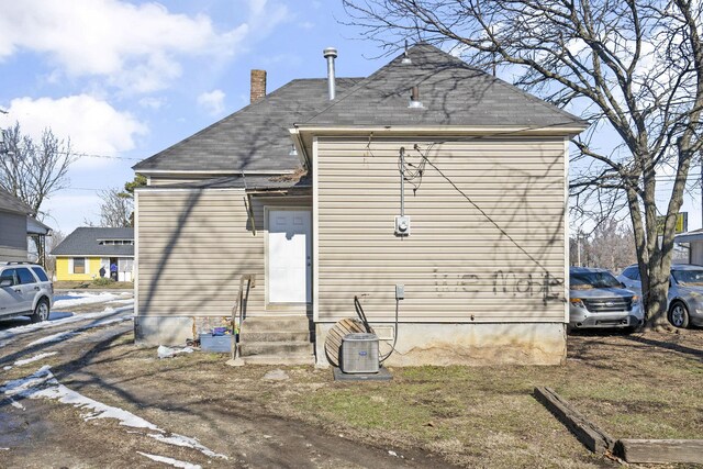 rear view of house featuring cooling unit