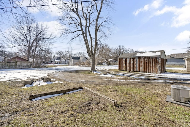 view of yard featuring central AC unit and a shed