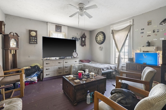 living room featuring ceiling fan, a textured ceiling, and dark hardwood / wood-style flooring