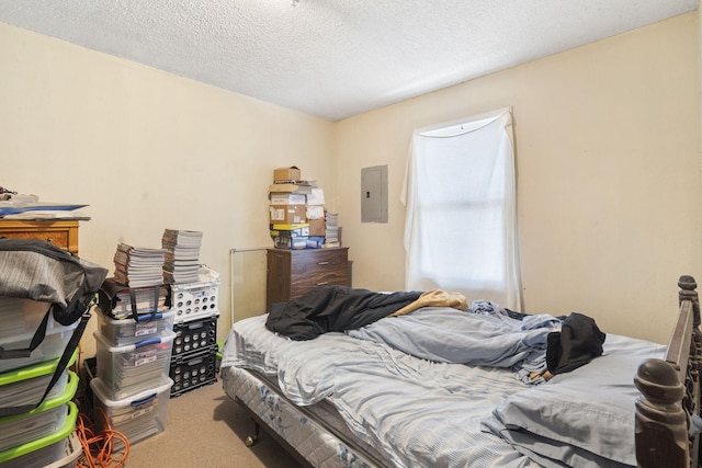 carpeted bedroom featuring a textured ceiling and electric panel