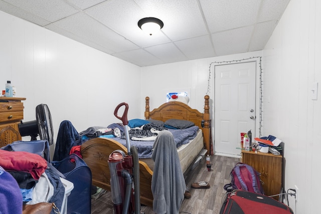 bedroom featuring a paneled ceiling and hardwood / wood-style flooring