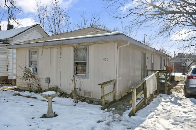 view of snow covered exterior featuring cooling unit