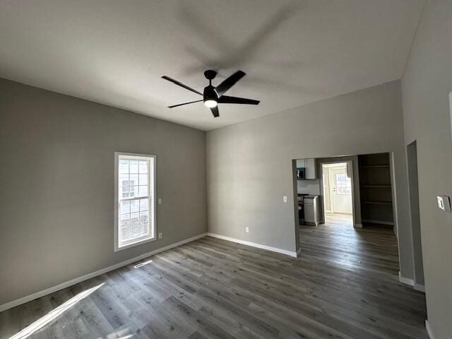 spare room with ceiling fan and dark hardwood / wood-style floors