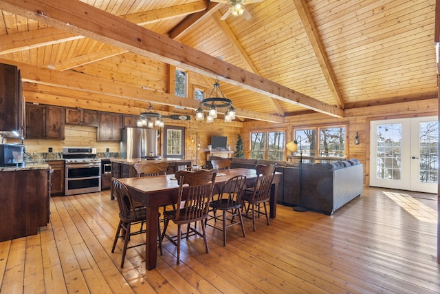 dining area featuring light hardwood / wood-style flooring, plenty of natural light, and beamed ceiling