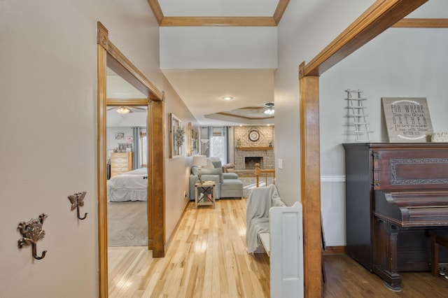 hall with ornamental molding and wood-type flooring