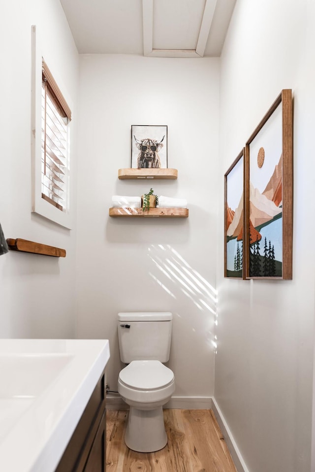 bathroom with toilet and hardwood / wood-style flooring