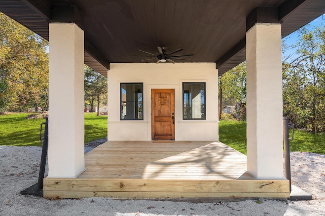 deck with ceiling fan and a yard