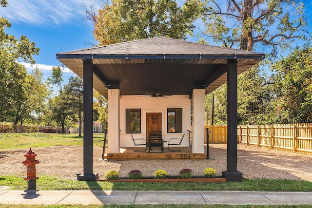 exterior space with ceiling fan