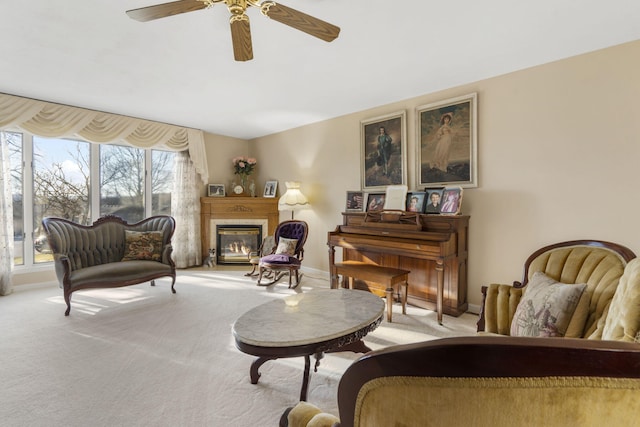 living area featuring ceiling fan and light colored carpet