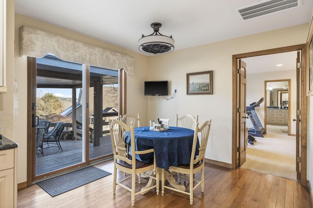 dining area with light hardwood / wood-style floors