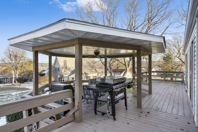 deck with ceiling fan and area for grilling