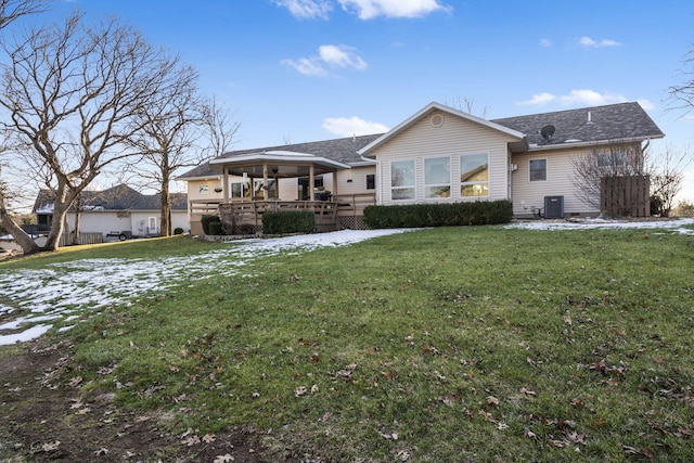 back of property with a lawn and central air condition unit