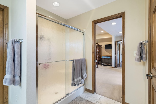 bathroom with tile patterned floors and a shower with shower door