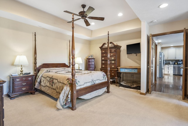 bedroom with light carpet, ceiling fan, and stainless steel refrigerator