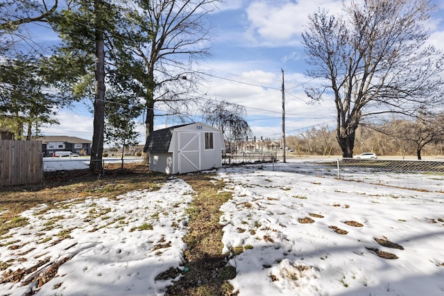 snowy yard with a storage unit