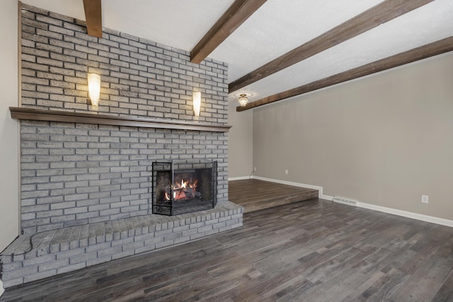 unfurnished living room with beam ceiling, wood-type flooring, and a fireplace