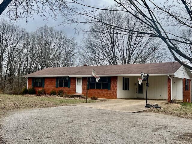 single story home featuring a carport