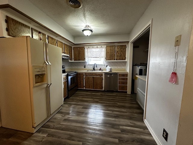 kitchen with dark hardwood / wood-style floors, range hood, decorative backsplash, sink, and stainless steel appliances