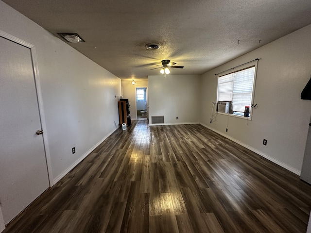 unfurnished room featuring ceiling fan, dark wood-type flooring, a textured ceiling, and a wealth of natural light