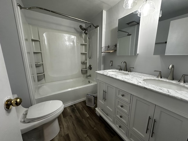 full bathroom featuring wood-type flooring, toilet, vanity, and shower / washtub combination