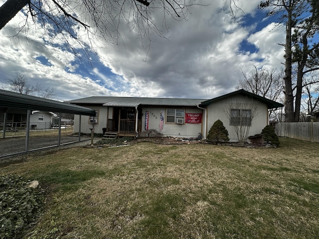 view of front of property with covered porch, a front lawn, and a carport