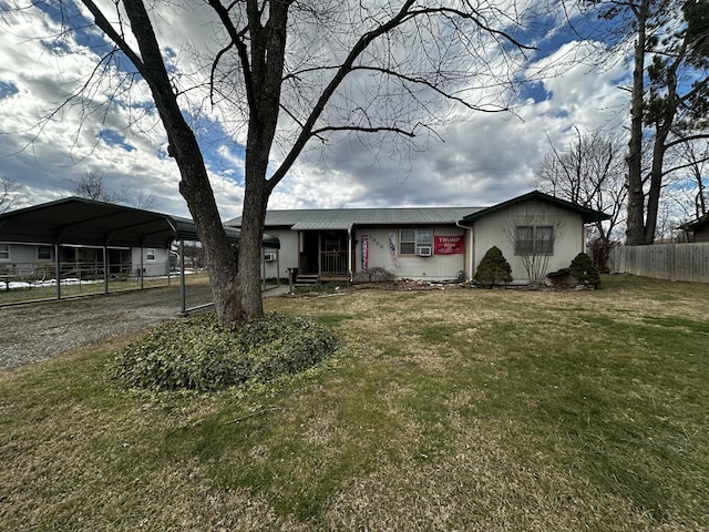 ranch-style home featuring a front lawn and a carport