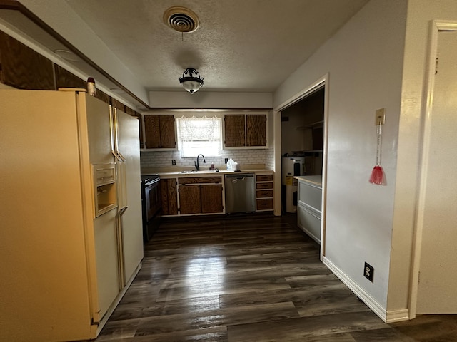 kitchen featuring dishwasher, decorative backsplash, sink, dark brown cabinetry, and white refrigerator with ice dispenser