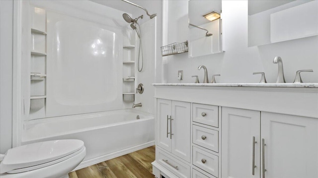 1933 Lynn Dr, West Plains, MO 65775 - bathroom featuring washtub / shower combination, toilet, wood finished floors, and vanity