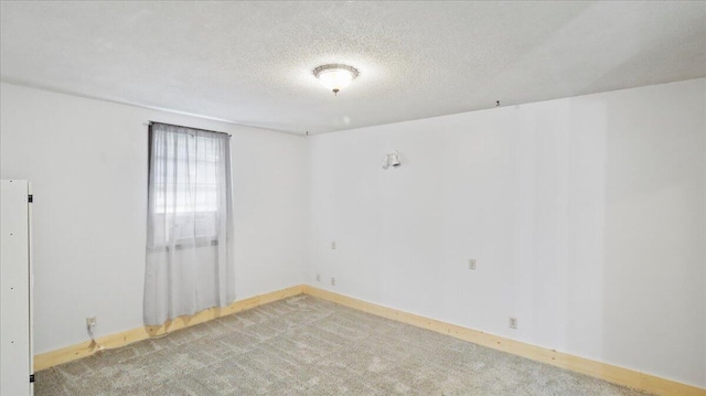 1933 Lynn Dr, West Plains, MO 65775 - carpeted spare room featuring a textured ceiling and baseboards