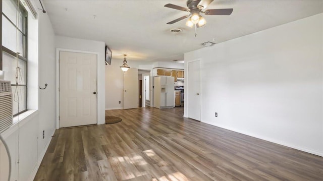 1933 Lynn Dr, West Plains, MO 65775 - unfurnished living room with wood finished floors, a ceiling fan, baseboards, and plenty of natural light