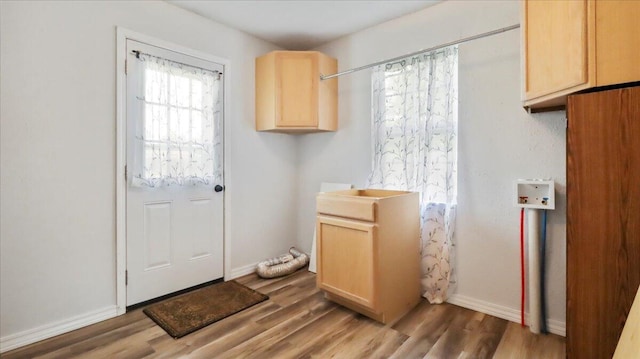 1933 Lynn Dr, West Plains, MO 65775 - laundry area with wood finished floors and baseboards