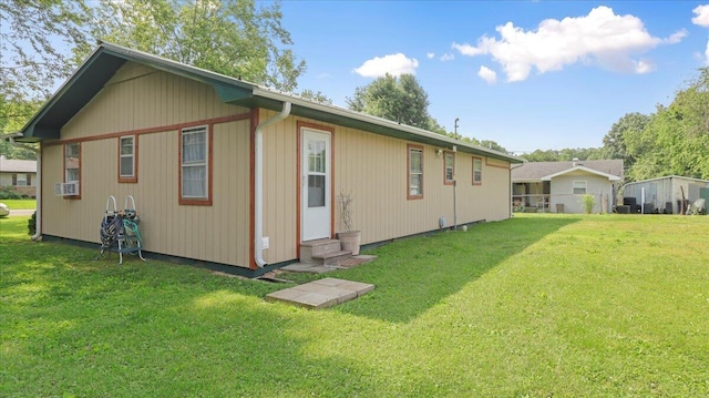 1933 Lynn Dr, West Plains, MO 65775 - rear view of property with entry steps, a lawn, and cooling unit