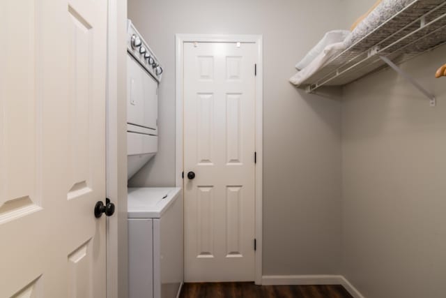 158 Troon Dr Unit 20, Branson, MO 65616 - laundry room featuring stacked washer / drying machine, dark wood finished floors, and baseboards