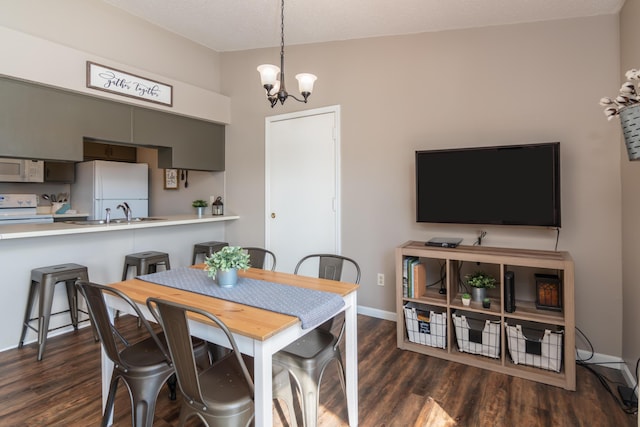 158 Troon Dr Unit 20, Branson, MO 65616 - dining space featuring a chandelier, dark wood finished floors, and baseboards