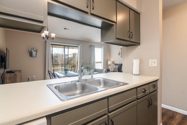 158 Troon Dr Unit 20, Branson, MO 65616 - kitchen featuring a sink, gray cabinetry, dark wood-style flooring, light countertops, and open floor plan