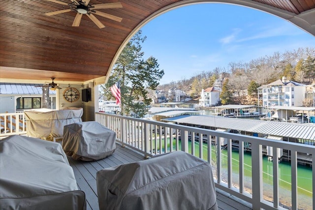 wooden terrace with grilling area and ceiling fan