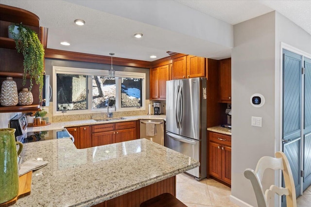 kitchen with stainless steel appliances, sink, hanging light fixtures, kitchen peninsula, and light tile patterned flooring