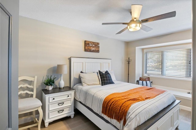 bedroom with ceiling fan and dark hardwood / wood-style flooring