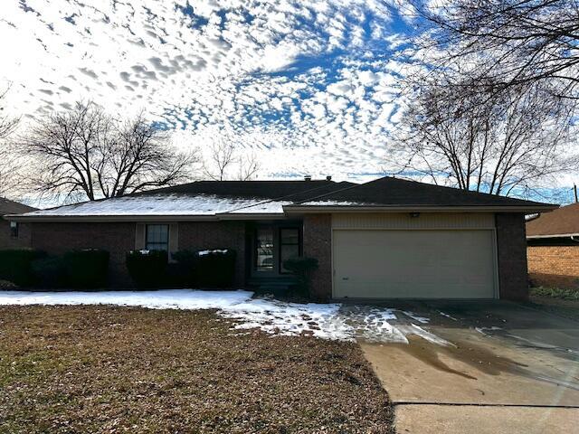 ranch-style home featuring a garage