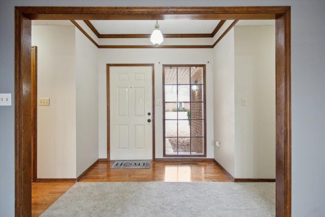 foyer featuring crown molding and light hardwood / wood-style floors