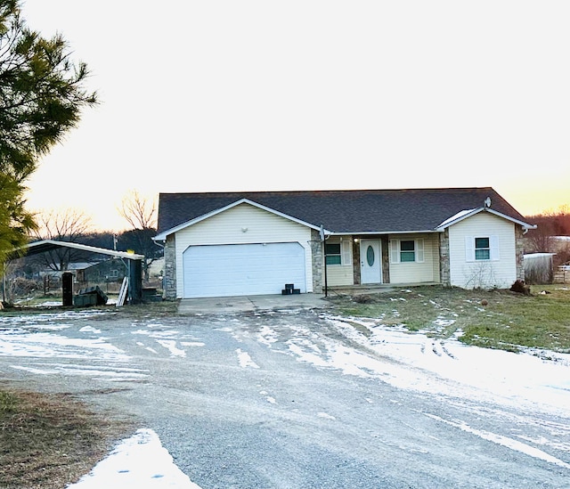 ranch-style home featuring a garage and a carport